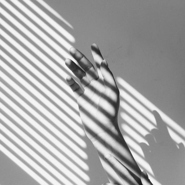 Abstract silhouette of a person meditating, with soft, flowing lines.